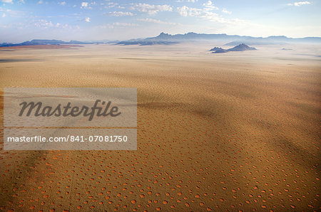Aerial view from hot air balloon over magnificent desert landscape of sand dunes, mountains and Fairy Circles, Namib Rand game reserve Namib Naukluft Park, Namibia, Africa
