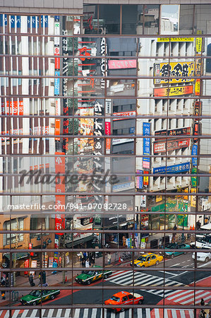 Street scene reflections at a busy Shibuya intersection, Tokyo, Honshu, Japan, Asia