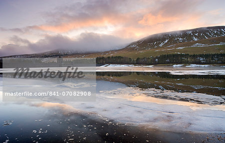 Broken ice floating on the Upper Neuadd Reservoir with Graig Fan Ddu in the background, Brecon Beacons National Park, Powys, Wales, United Kingdom, Europe