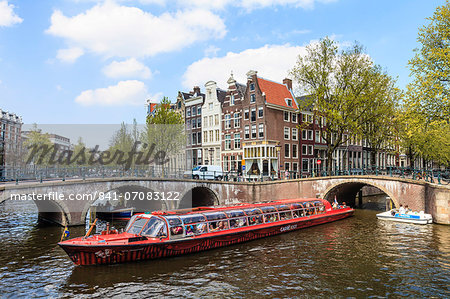 Tourist boat crossing Keizersgracht Canal, Amsterdam, Netherlands, Europe