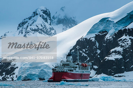 Cruise ship in front of the glaciers and icefields of Danco Island, Antarctica, Polar Regions