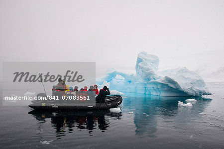 Tourists in a Zodiac crusing through icebergs, Enterprise Island, Antarctica, Polar Regions