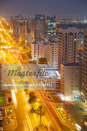 City skyline and Rashid Bin Saeed Al Maktoum Street at dusk, Abu Dhabi, United Arab Emirates, Middle East