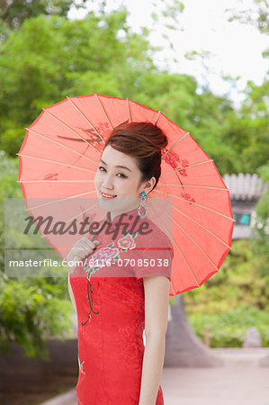 Young Woman in Qipao with Umbrella