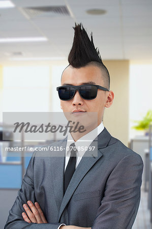Well-dressed young man with Mohawk and sunglasses