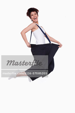 Girl in oversized pants jumping