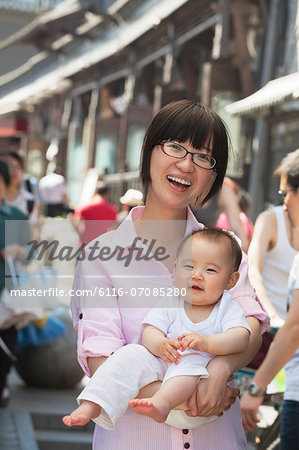 Portrait of mother holding her baby son, outdoors Beijing