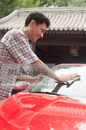 Young Man Cleaning His Car