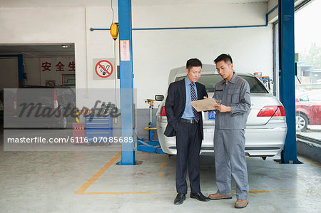 Garage Mechanic Explaining to Customer