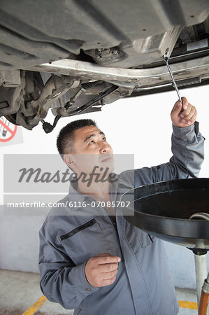 Mechanic Changing the Oil