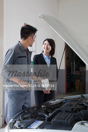 Mechanic Chatting and Laughing with Customer