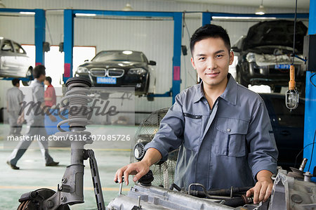 Mechanic Fixing Car Engine