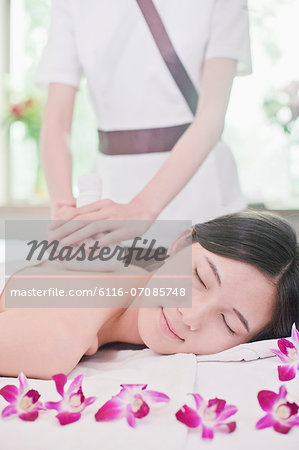Women Receiving Herbal Massage