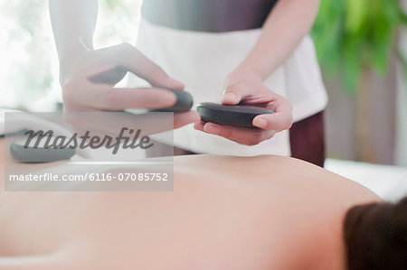 Woman Receiving Hot Stone Massage