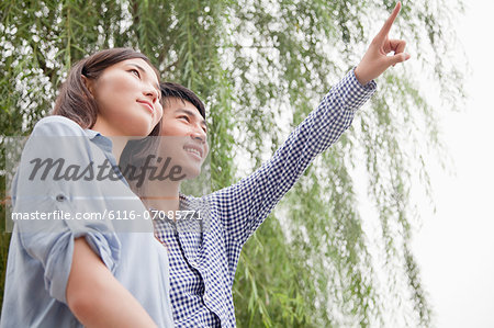 Young Man Pointing Something Out to His Girlfriend