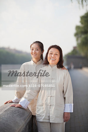 Two Chinese Women With Tai Ji Clothes Smiling At Camera