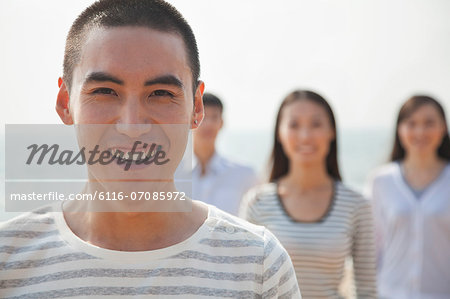 Portrait of Young Man and Friends at Beach