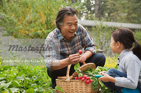 Grandfather and granddaughter in garden