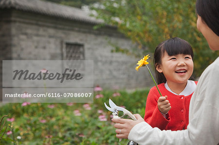 Smiling young girl with flower