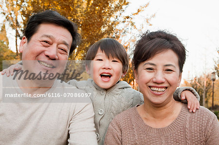 Portrait of Grandparents and Grandson in the Park