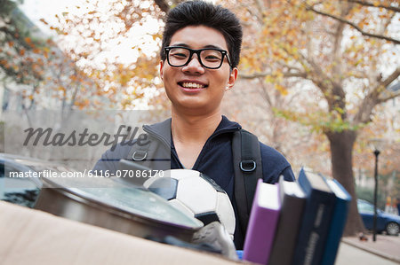 Student in front of dormitory at college