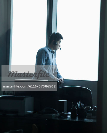 Man looking through window in office