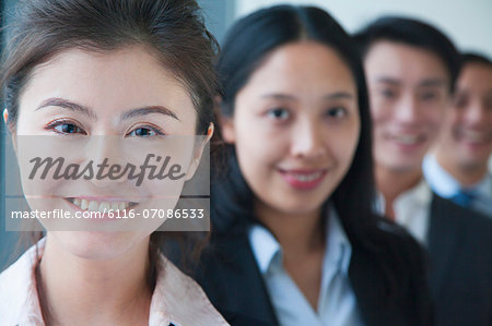 Businesswoman with co-workers portrait
