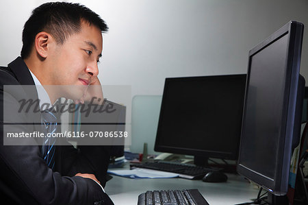 White-collar worker sitting in front of computer in office