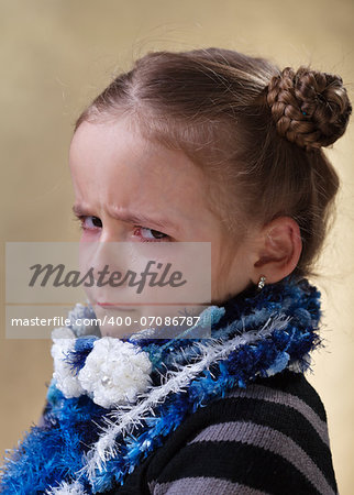 Sulking young girl with tears in her eyes - closeup portrait
