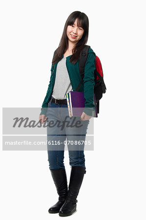 Smiling female student carrying books, portrait