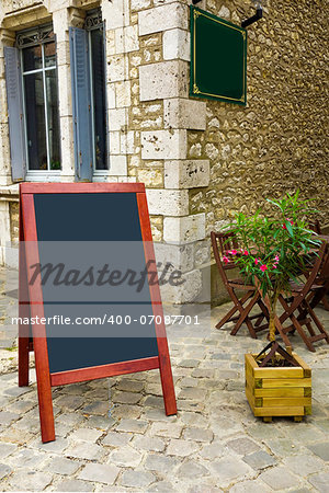 street view of a Restaurant's terrace with blackboard
