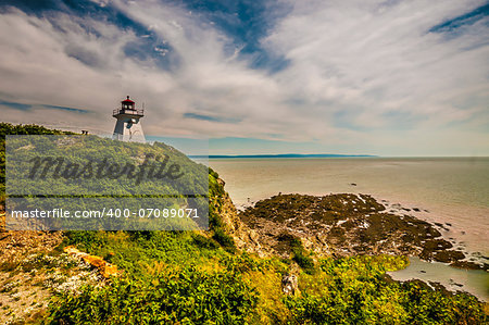 Lighthouse of the eroded cliff and beach located in Cape Enrage New Brunswick Canada