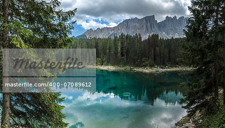 Carezza lake and Latemar in summer season with clouds, Dolomites - Italy