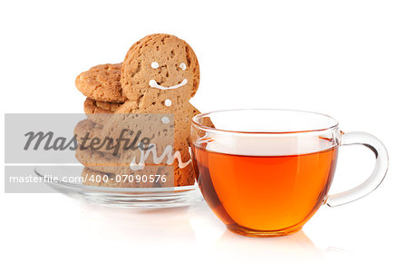 Glass cup of black tea with homemade cookies and gingerbread man. Isolated on white background
