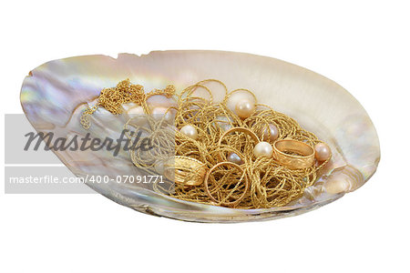 Golden chains, rings and pearls in mother of pearl. Isolated on a white background.