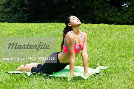 Young woman doing yoga in the park