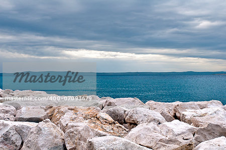 Breakwaters on the sea coast and cloudy skies