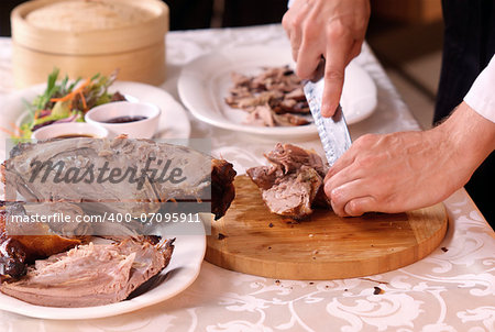 cooking a delicious roast duck with spices in restaurant