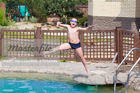 child jumps into the pool with water