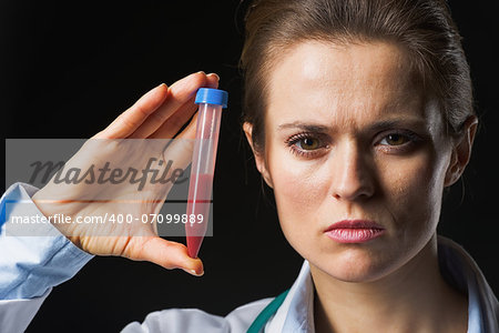 Doctor woman showing test tube isolated on black