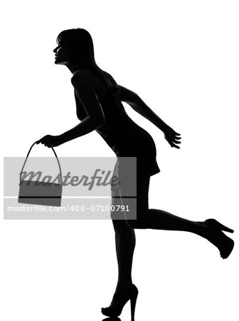 stylish silhouette caucasian beautiful woman running holding purse full length on studio isolated white background