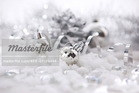 Silver christmas decorations - balls, snow, ribbon. Soft focus.