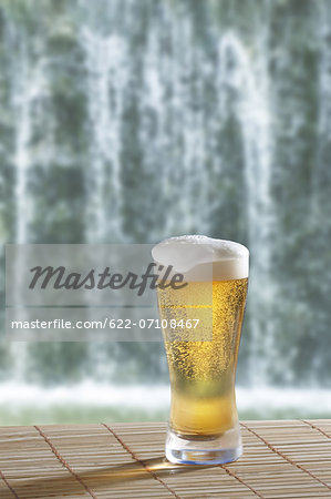 Glass of beer and waterfall