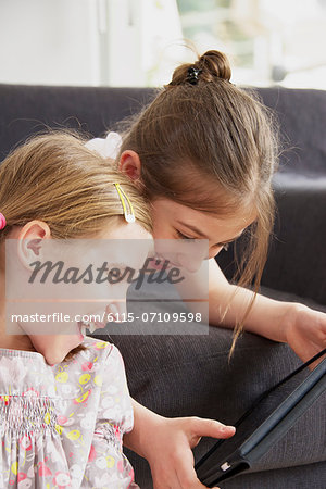 Two girls using digital tablet, Munich, Bavaria, Germany