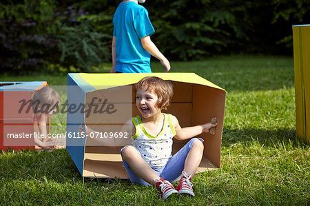 Children playing with cardboard boxes, Munich, Bavaria, Germany