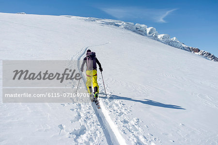 Backcountry skier ploughing through snow, European Alps, Tyrol, Austria