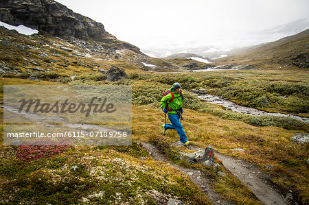 Man speed hiking along mountain trail, Norway, Europe