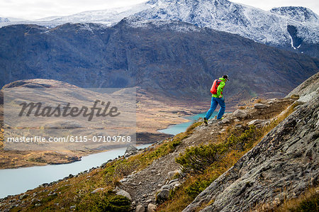 Man speed hiking along mountain trail, Norway, Europe