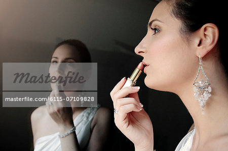 Bride applying lipstick, reflection in mirror, Zagreb, Croatia