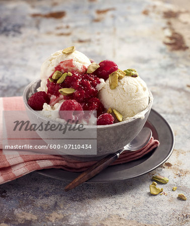 Bowl of Ice Cream with Raspberries and Pistachio Nuts, Studio Shot